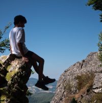 Ado assis sur une roche dans le vide